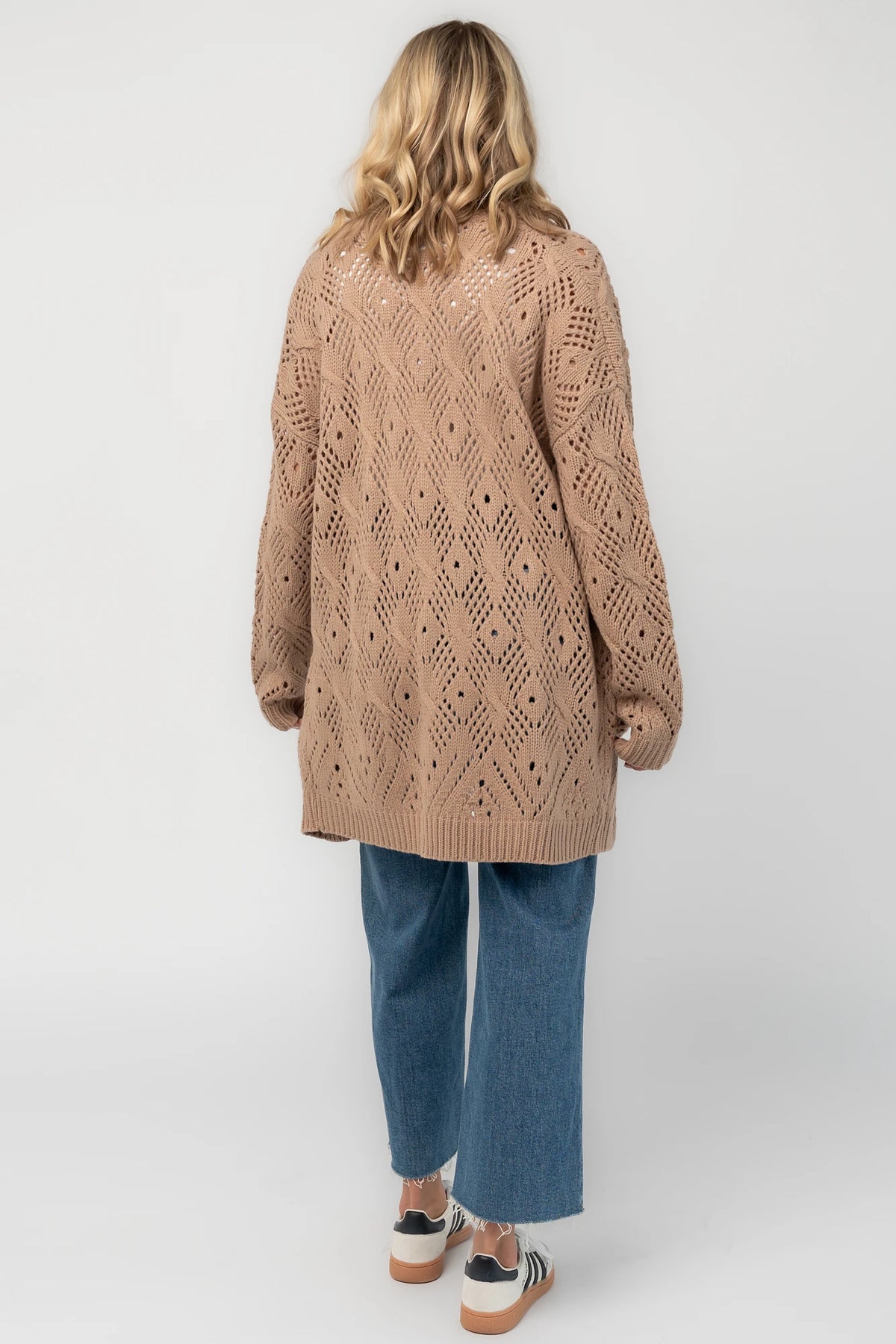 Light mocha open-front pointelle knit cardigan with long balloon sleeves, front patch pockets, ribbed trim, and a relaxed oversized silhouette.