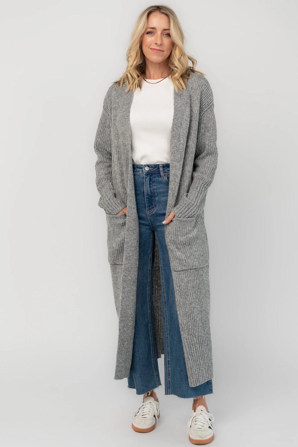 Heather gray ribbed long cardigan with an open front, long sleeves, front patch pockets, and a relaxed full-length silhouette.