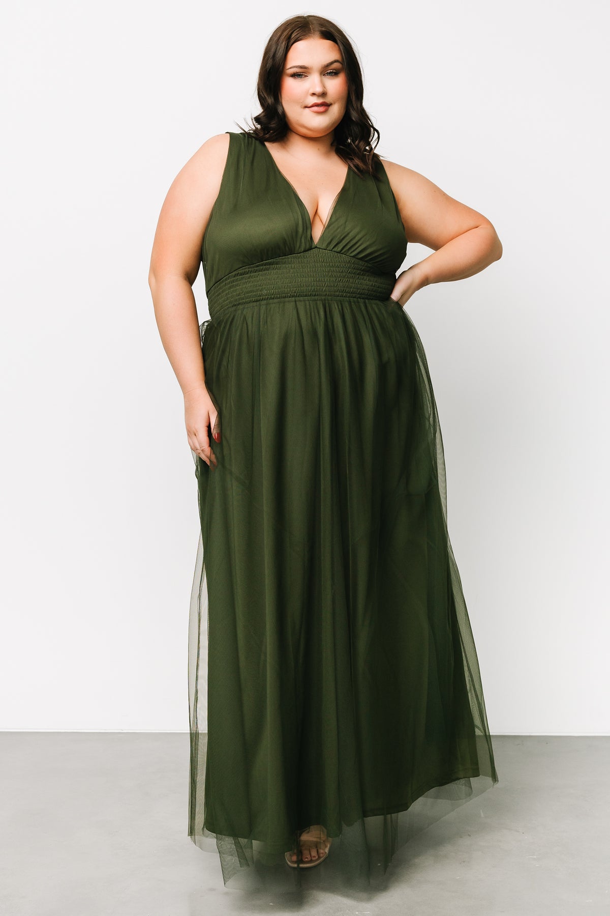 Three-quarter profile of Kamila Tulle Maxi Dress in Juniper Green showing short tank sleeves, fitted smocked waist, and soft tulle layers across the skirt.