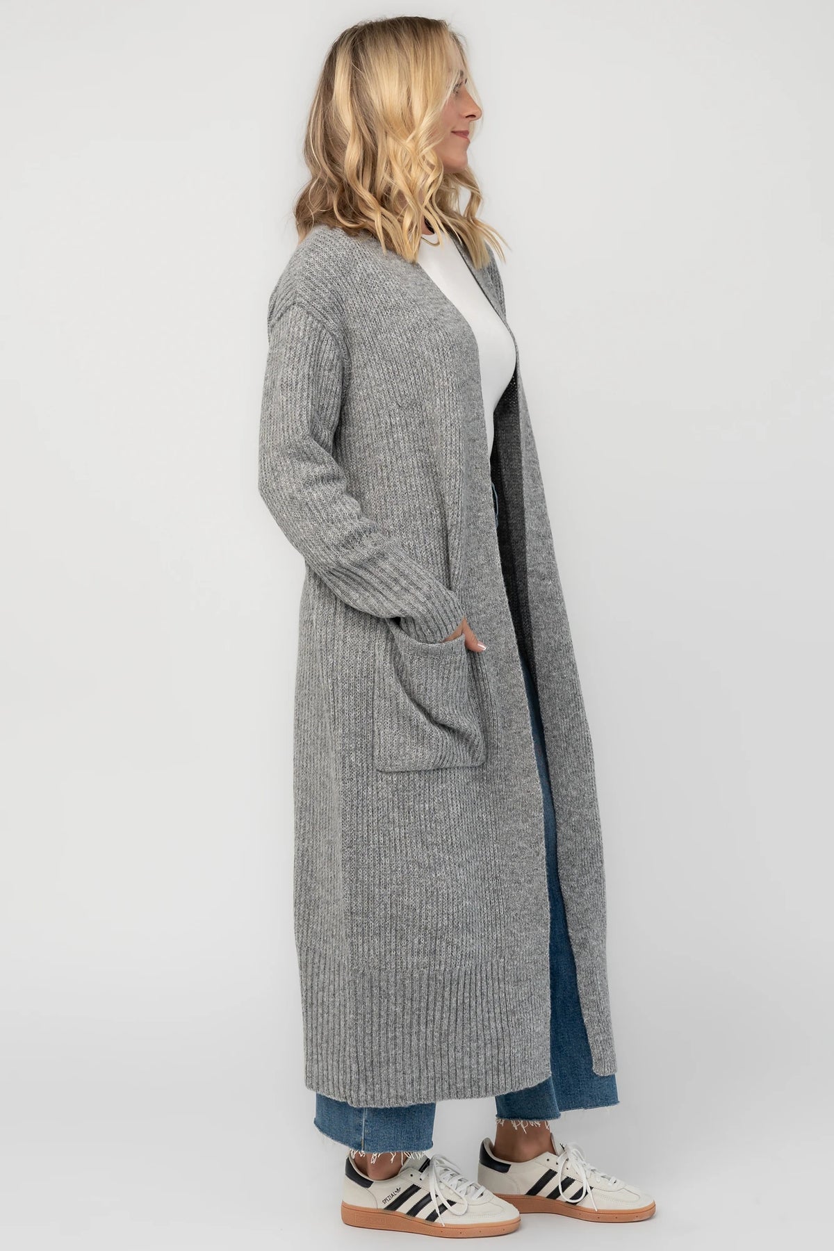 Heather gray ribbed long cardigan with an open front, long sleeves, front patch pockets, and a relaxed full-length silhouette.