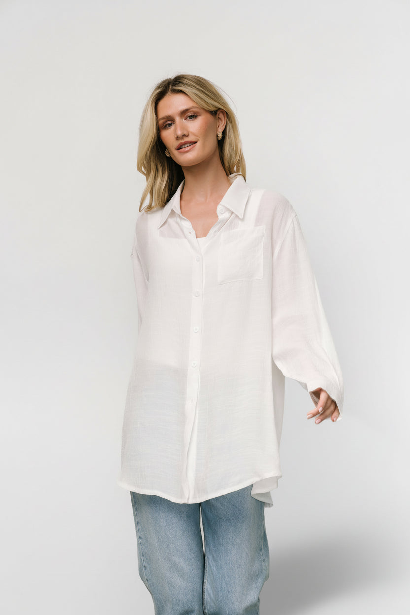 Close-up detail of Breck Button Up Top fabric and buttons; lightweight, textured linen-like weave with stitched cuff.
