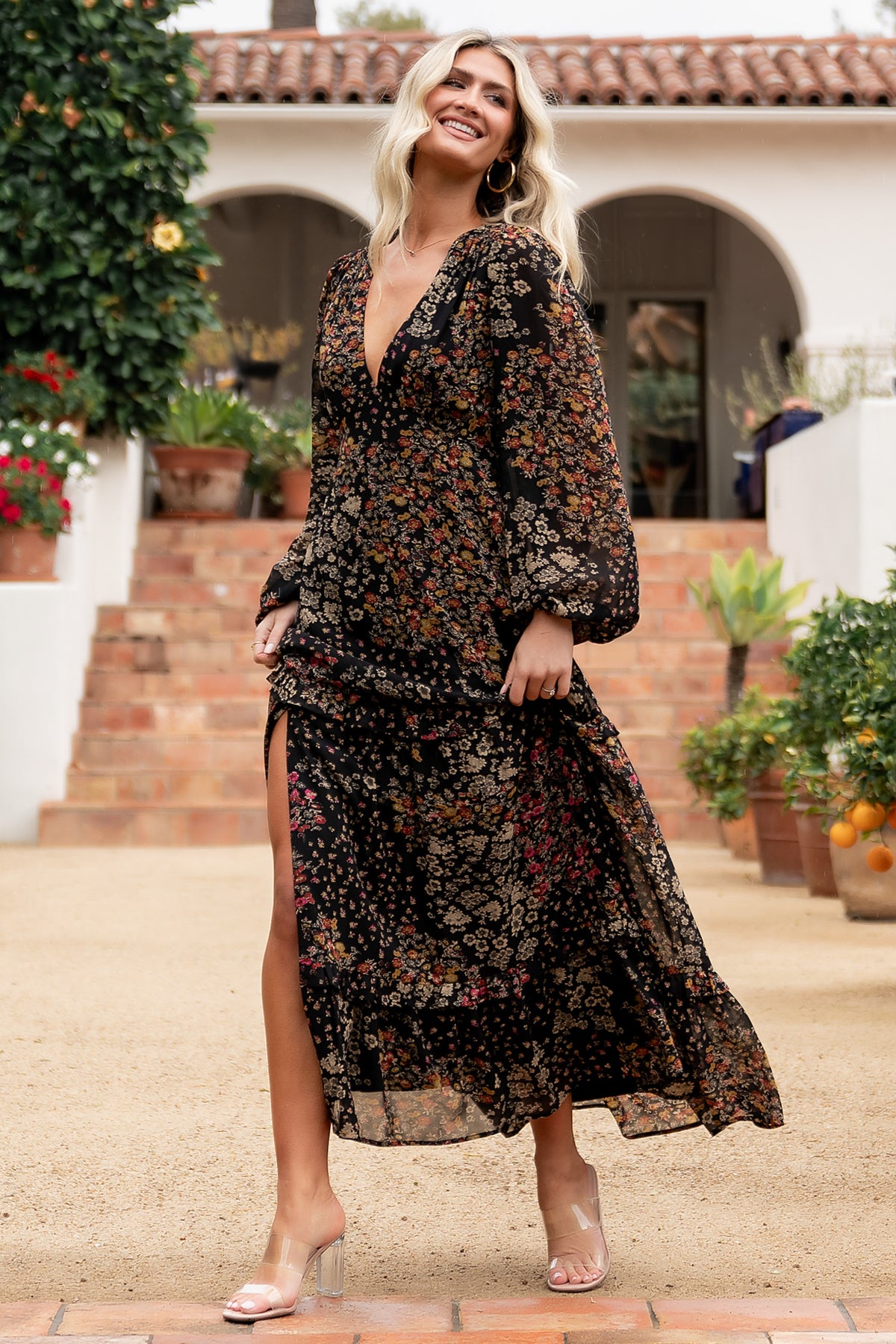 Bowman Deep V Tiered Maxi Dress in Black Multi with deep V-neck, long sleeves, ruffle-tiered skirt, and leg slit.