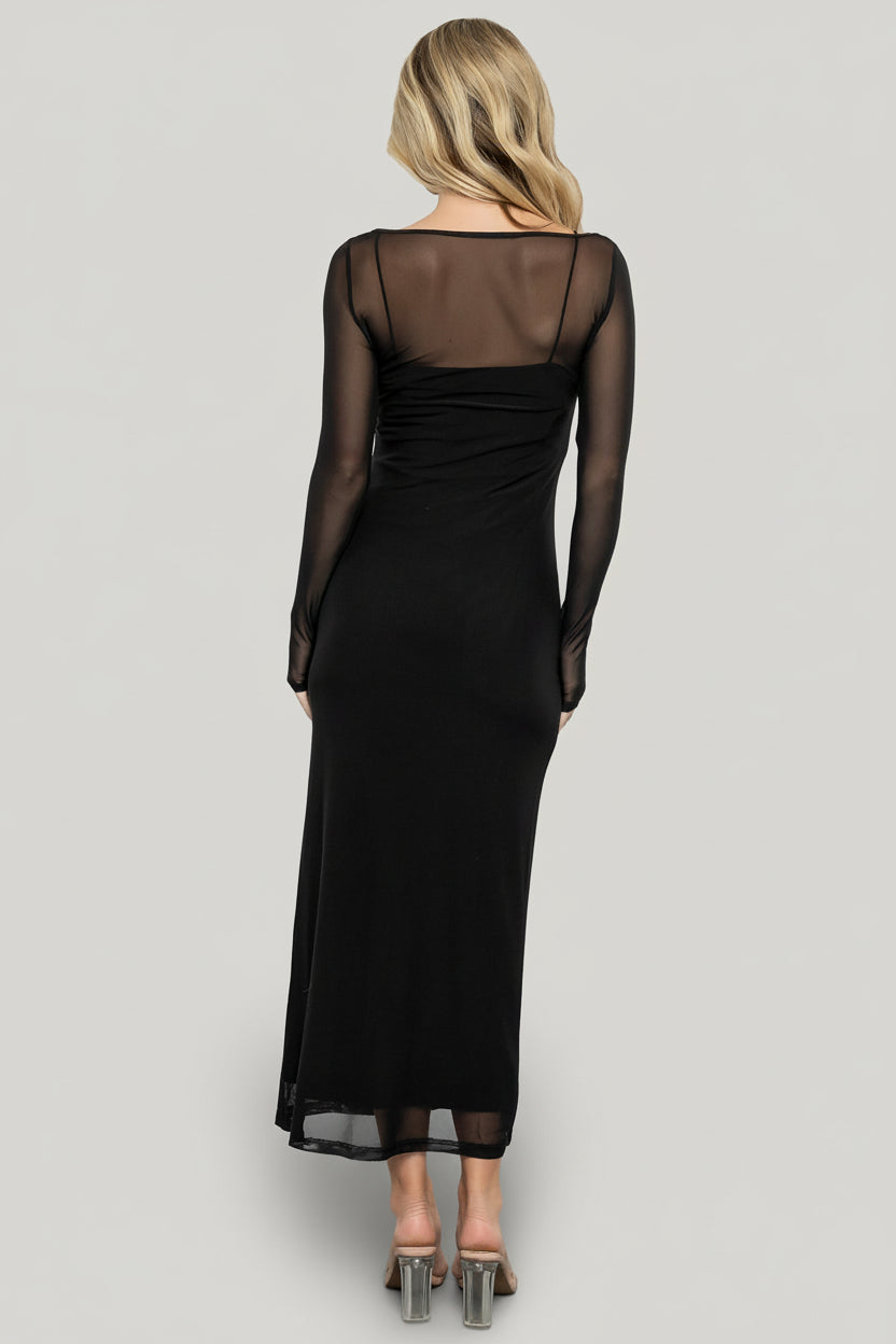 Lifestyle shot of the Darya dress styled for an event, featuring the black mesh overlay, ribbed slip, and long sleeves for a polished look.