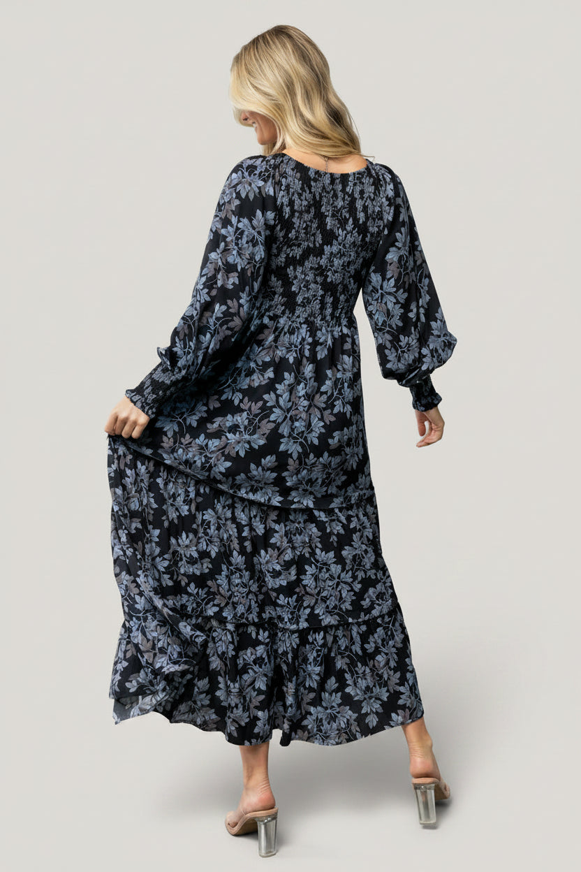 Side view of the Rayna Smocked Maxi Dress showing tiered skirt movement and mid-weight fabric texture in blue floral.