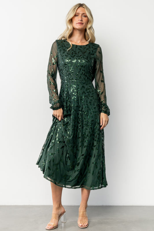 Front view of emerald Kalla sequin midi dress on model, showing A-line silhouette and long sheer sleeves with elastic cuffs.