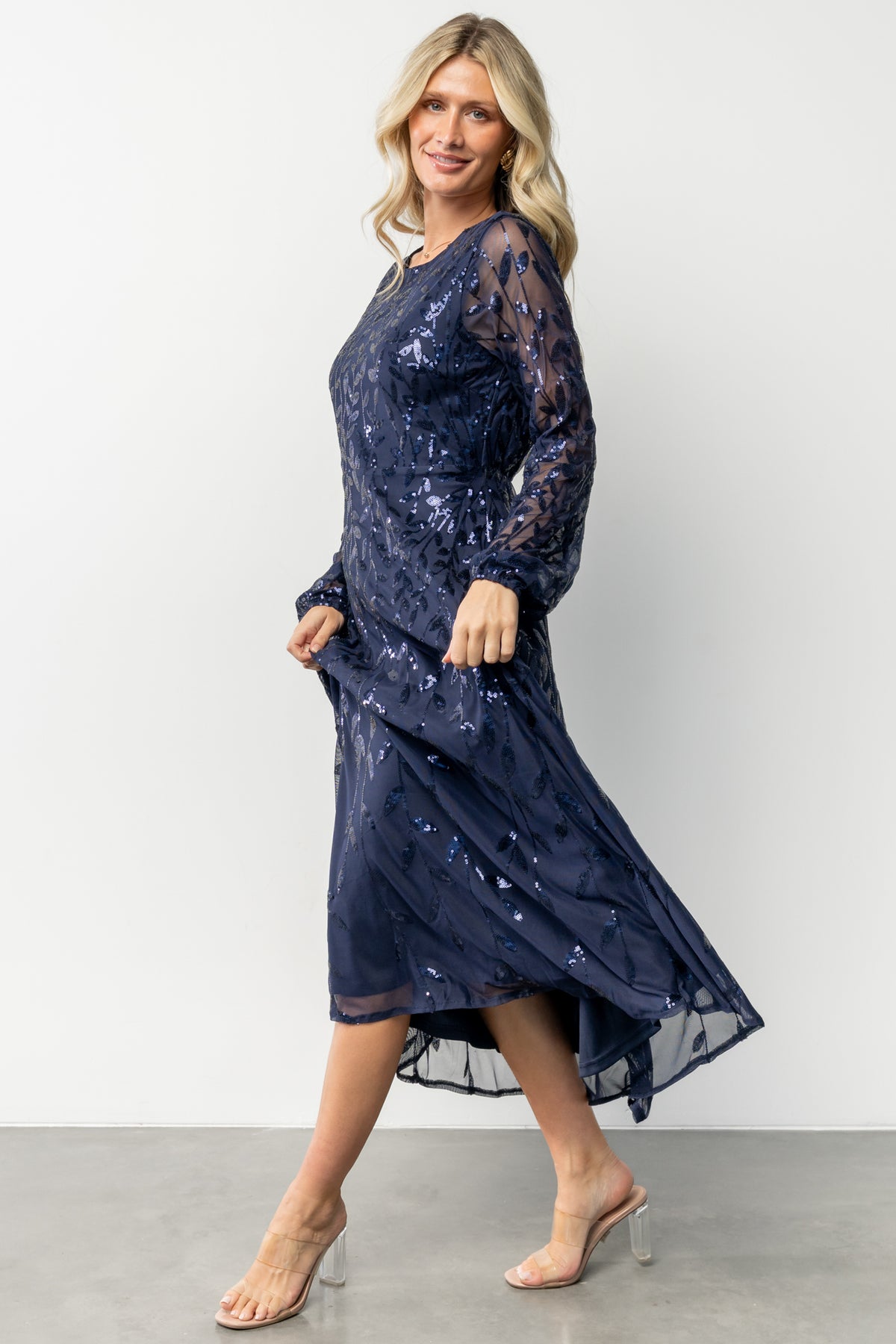 Studio shot of the dress fabric and lining edge, illustrating that the body is fully lined while sleeves remain sheer mesh.