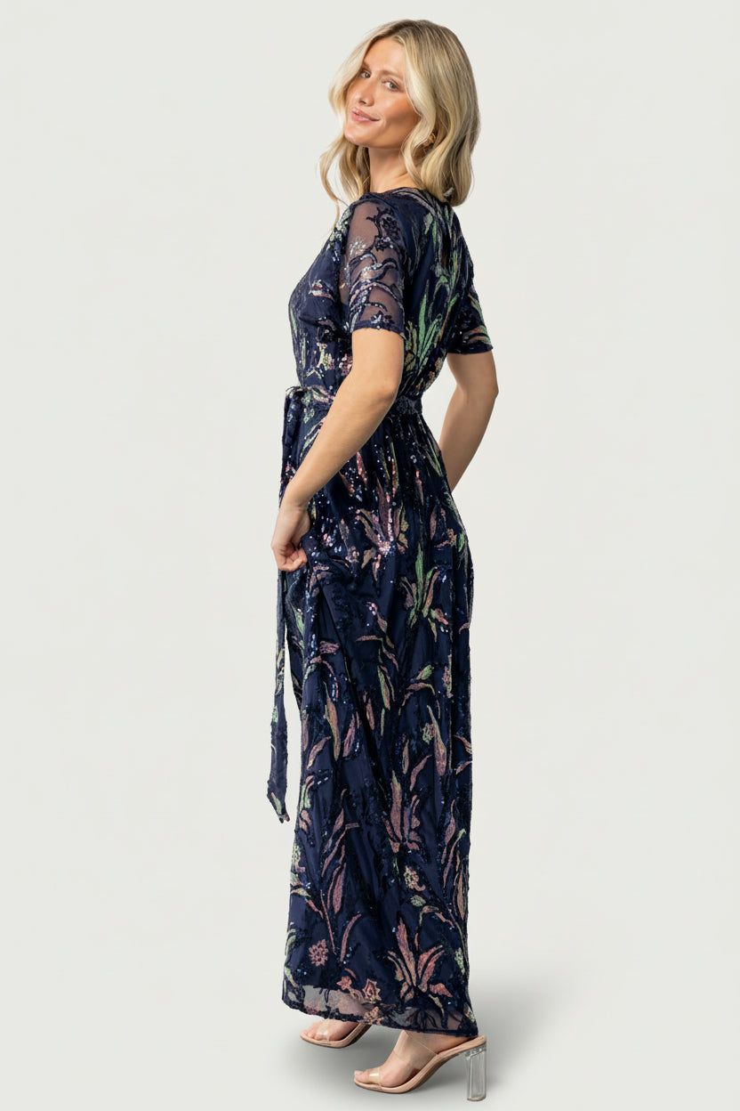 Close-up of sequin leaf detailing on the Muse Sequin Maxi Dress showing multi-toned sequins on dark blue fabric for a subtle shimmer.