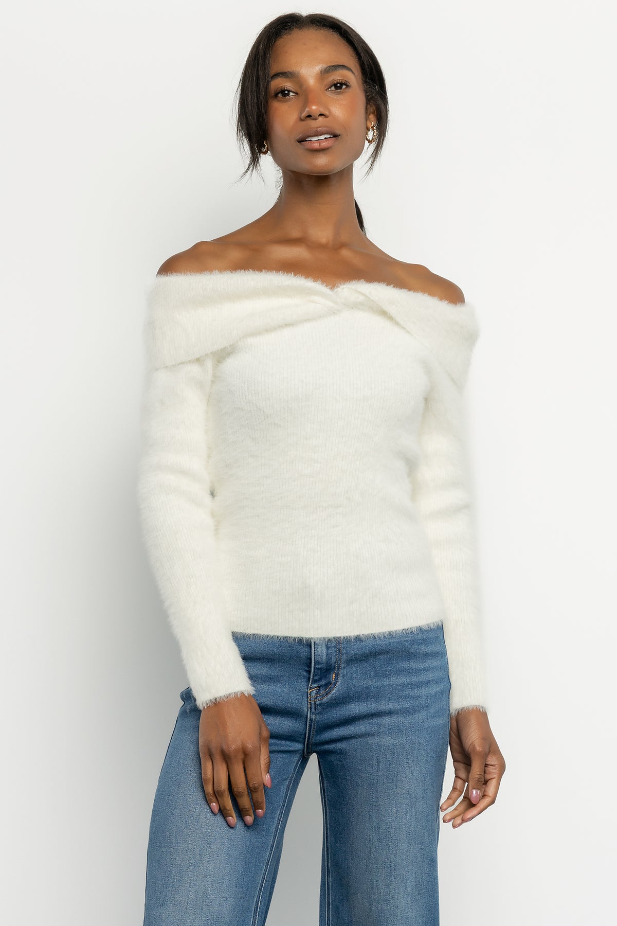 Close-up of Perla ivory sweater texture and foldover neckline highlighting the plush fuzzy knit and stitch detail.
