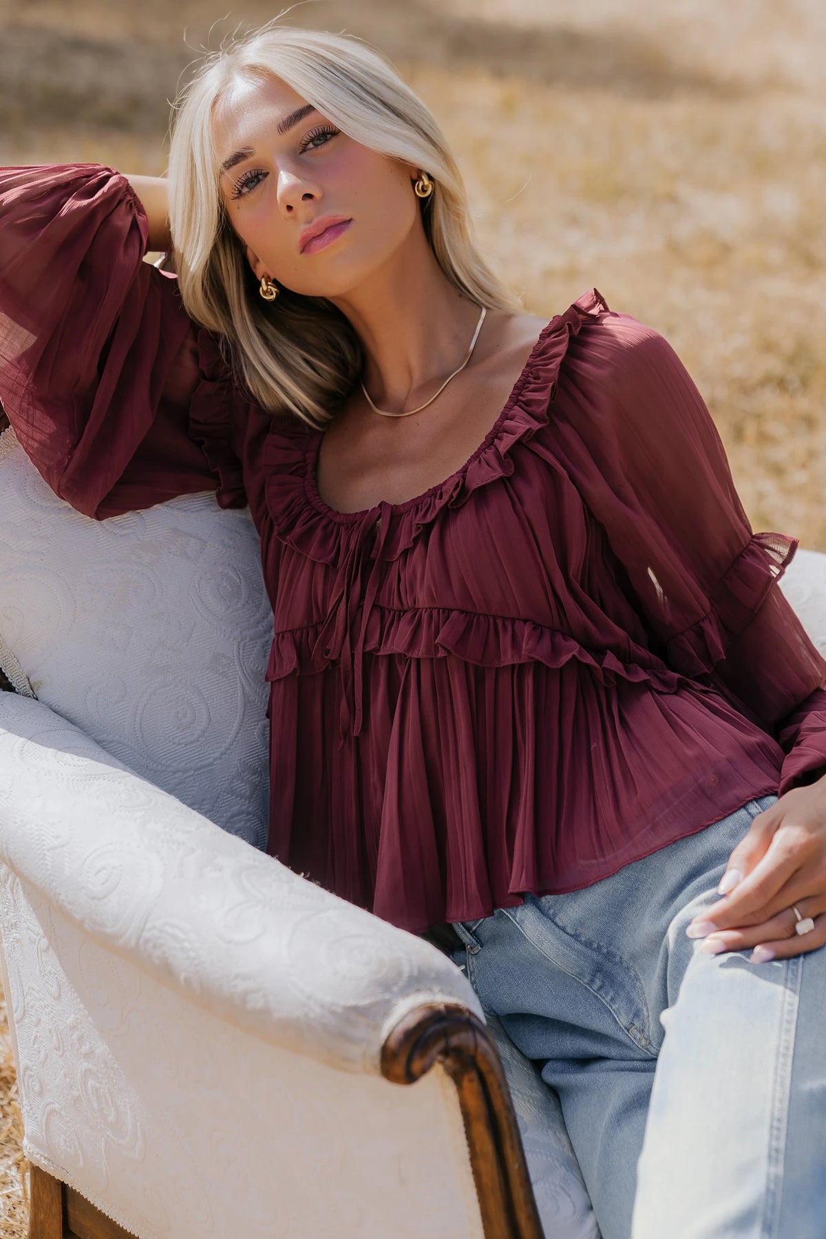 Bellerose Ruffle Top in Burgundy with pleated chiffon, ruffle-trimmed neckline, front tie, and billowy long sleeves.