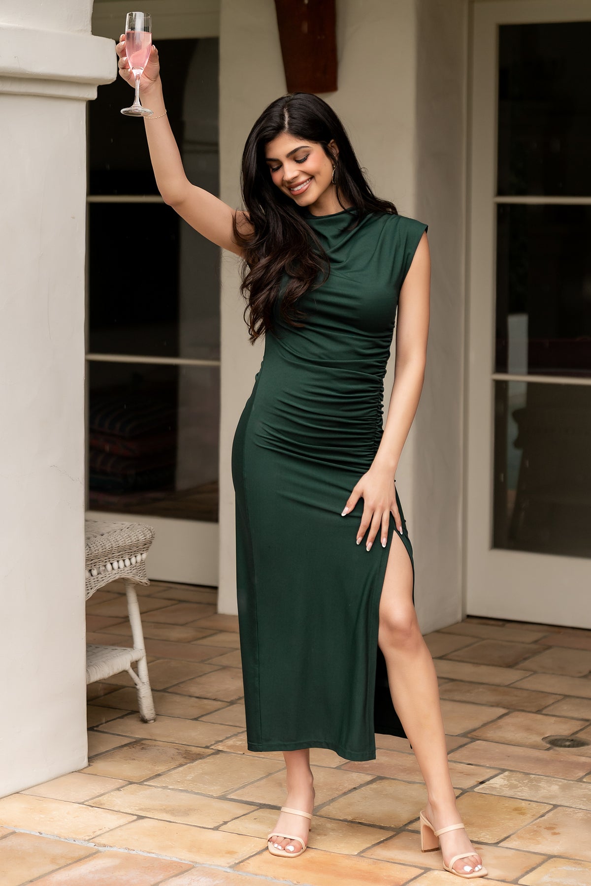 Back view of the Sasha Ruched Maxi Dress in deep green on model, showing fully lined construction and the clean skirt drape.