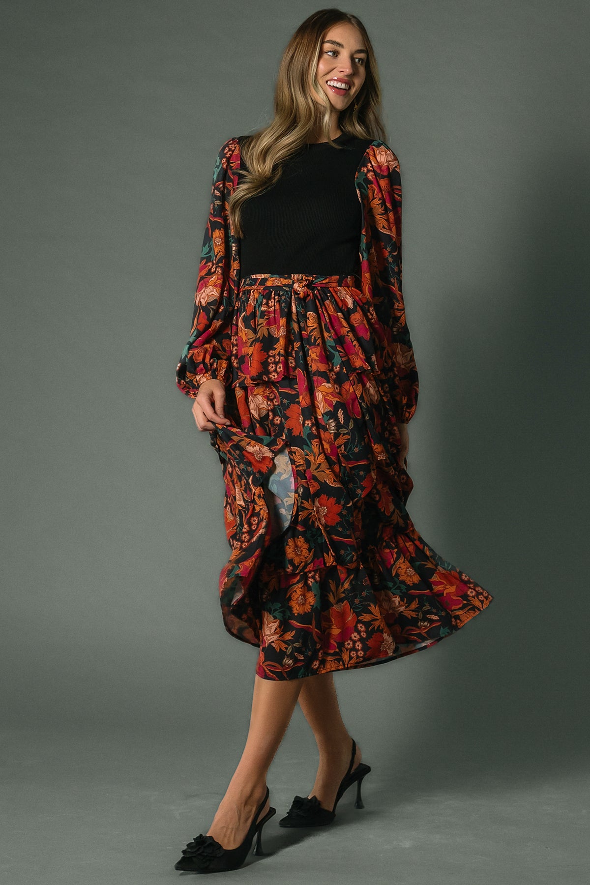 Close-up of Sylvie Tiered Midi Dress floral print and chiffon sleeve, highlighting ruffle detail and textured knit bodice.