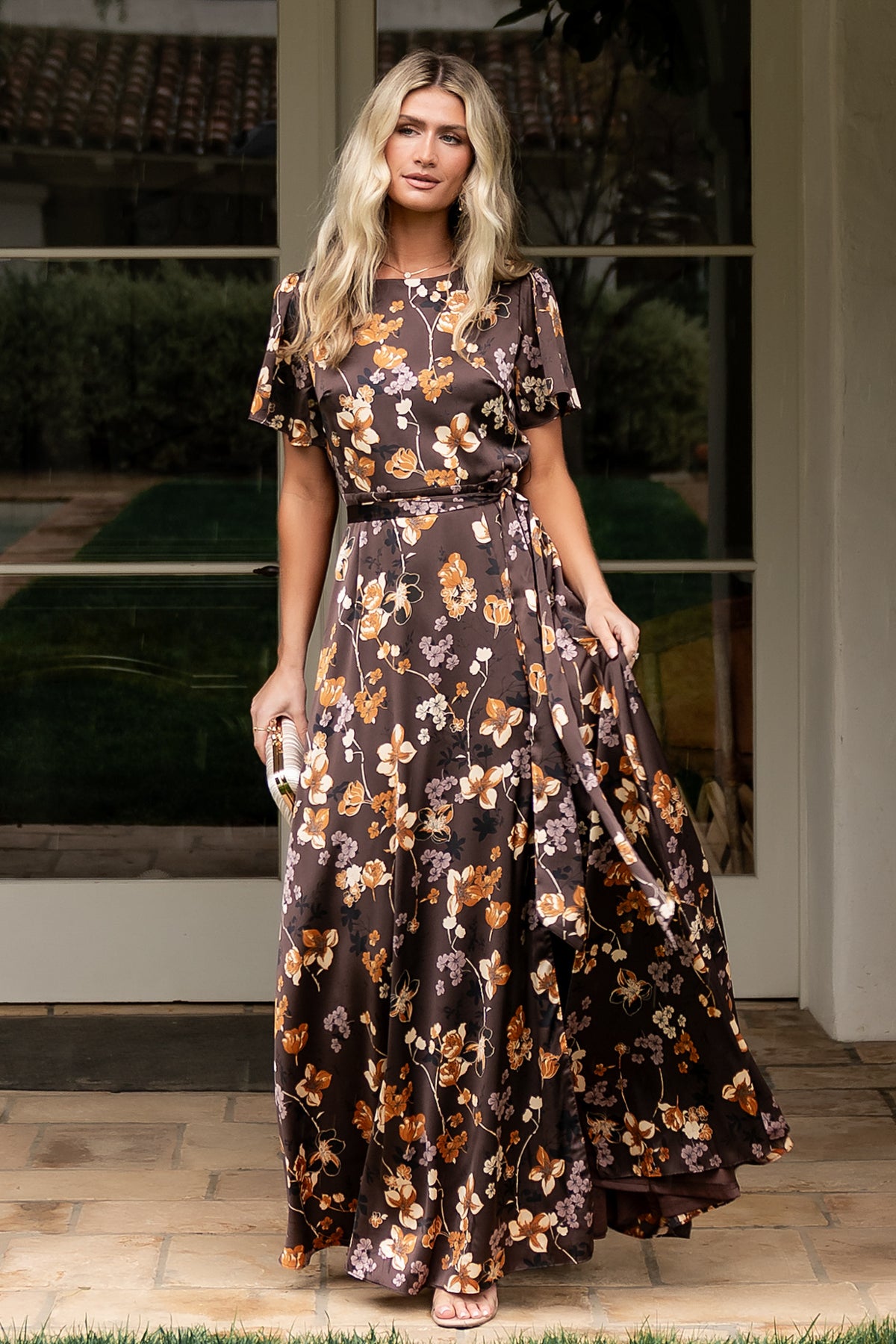 Close-up of brown floral satin fabric and print, highlighting the sheen, pattern scale, and soft stretch of the material.