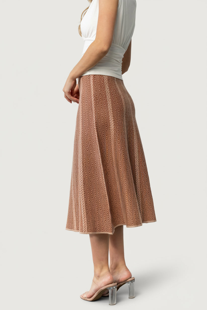 Close-up detail of the petite chevron knit pattern in rust and taupe, showing texture and medium-weight knit construction.