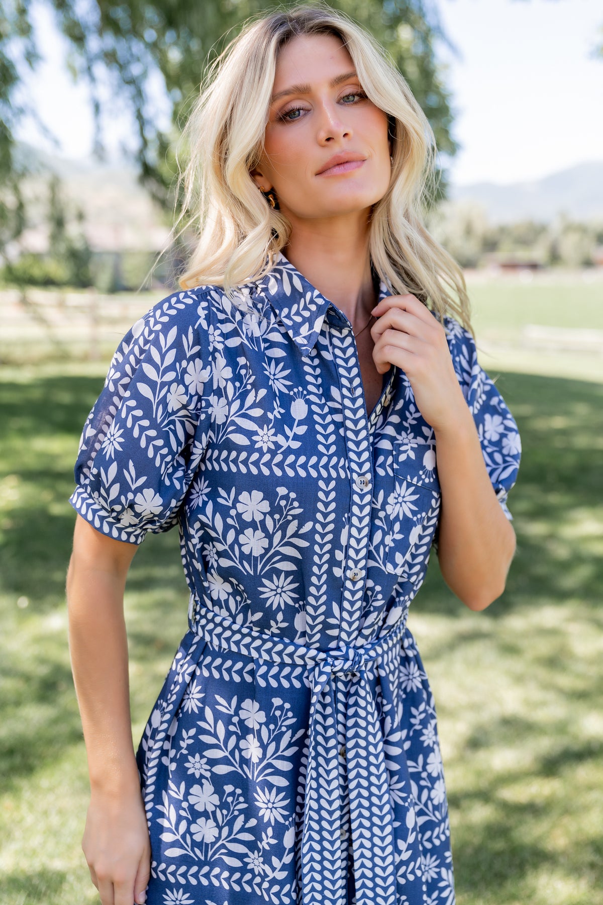 Back view of Karla midi dress showing adjustable waist sash tied at the back and the dress length falling to mid-shin on model.