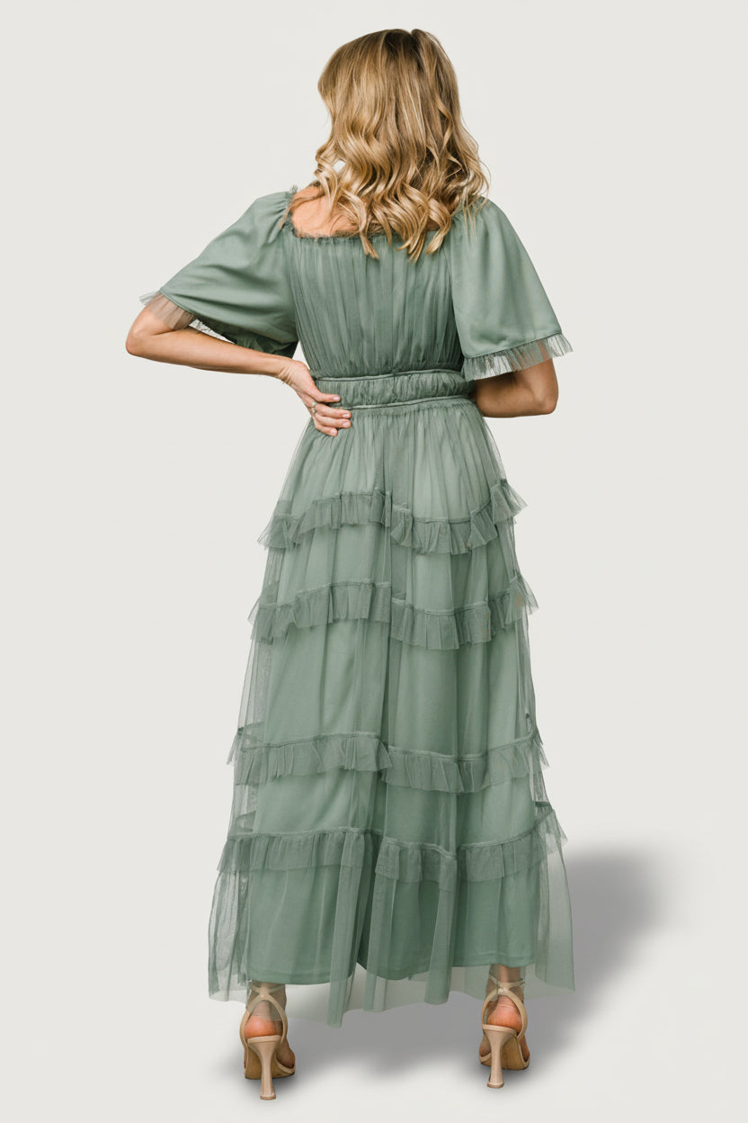 Model portrait wearing Magdalena Tulle Maxi Dress in eucalyptus, highlighting short ruffled sleeves and elasticized waist detail.