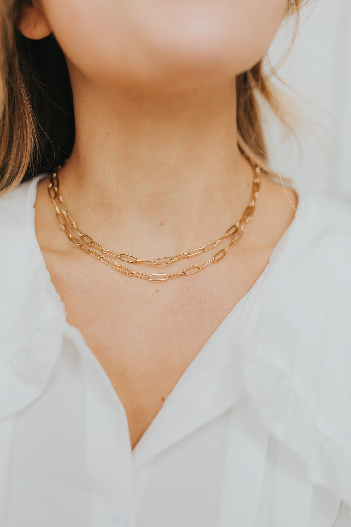 Two Eloise Necklaces layered together to display scale and luminous 18K gold finish, photographed on a neutral background to emphasize texture.