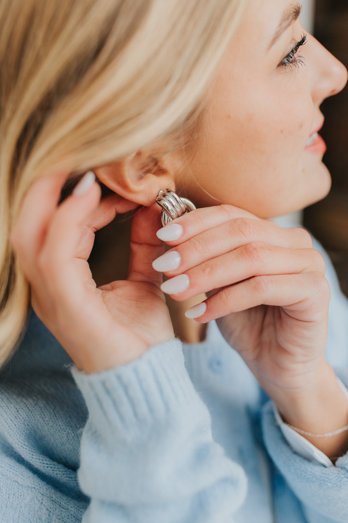 Close-up of Hailey Earrings in silver showing interlocking hoops, brushed and polished surfaces, and the post-back fastening detail.