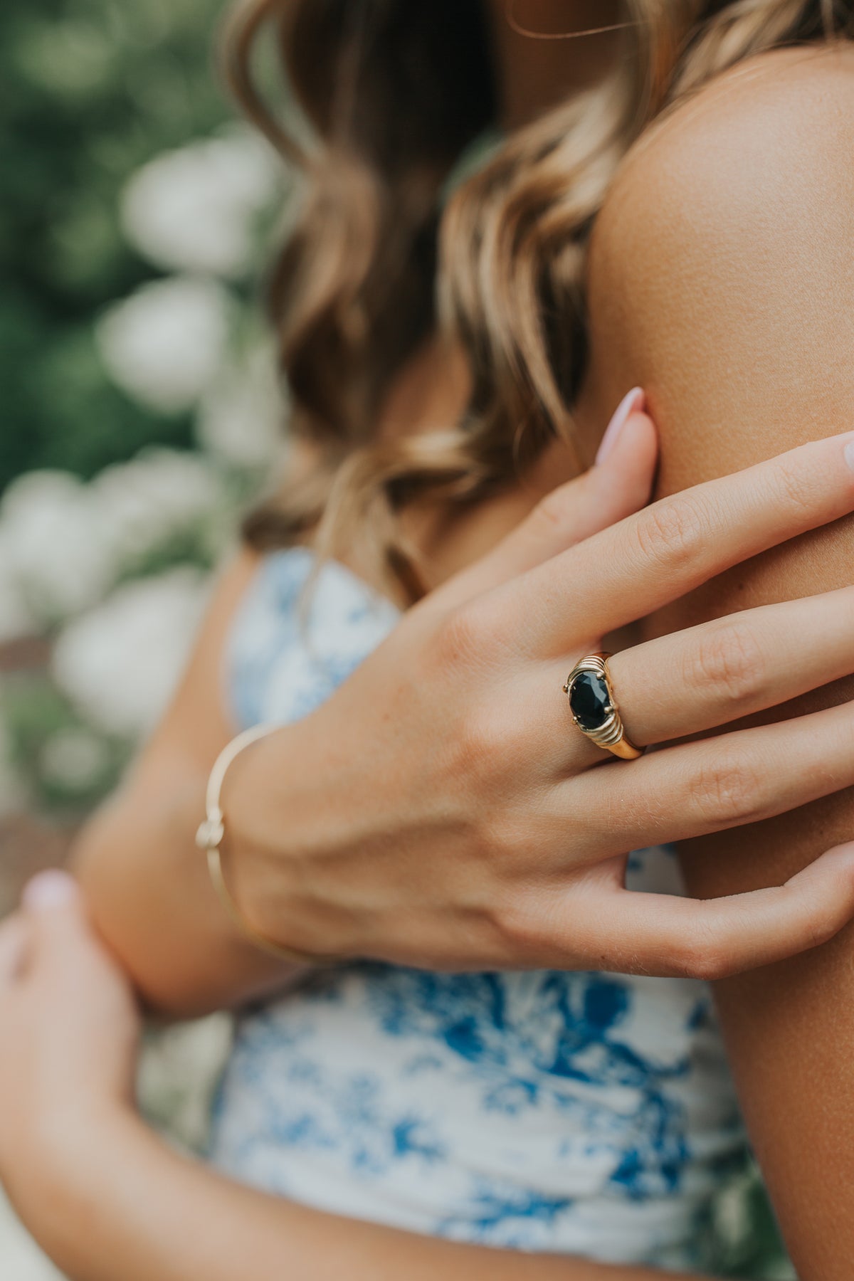 Side profile of Maddie ring revealing prong-set oval onyx, sculpted band silhouette, and lightweight design for comfortable wear.