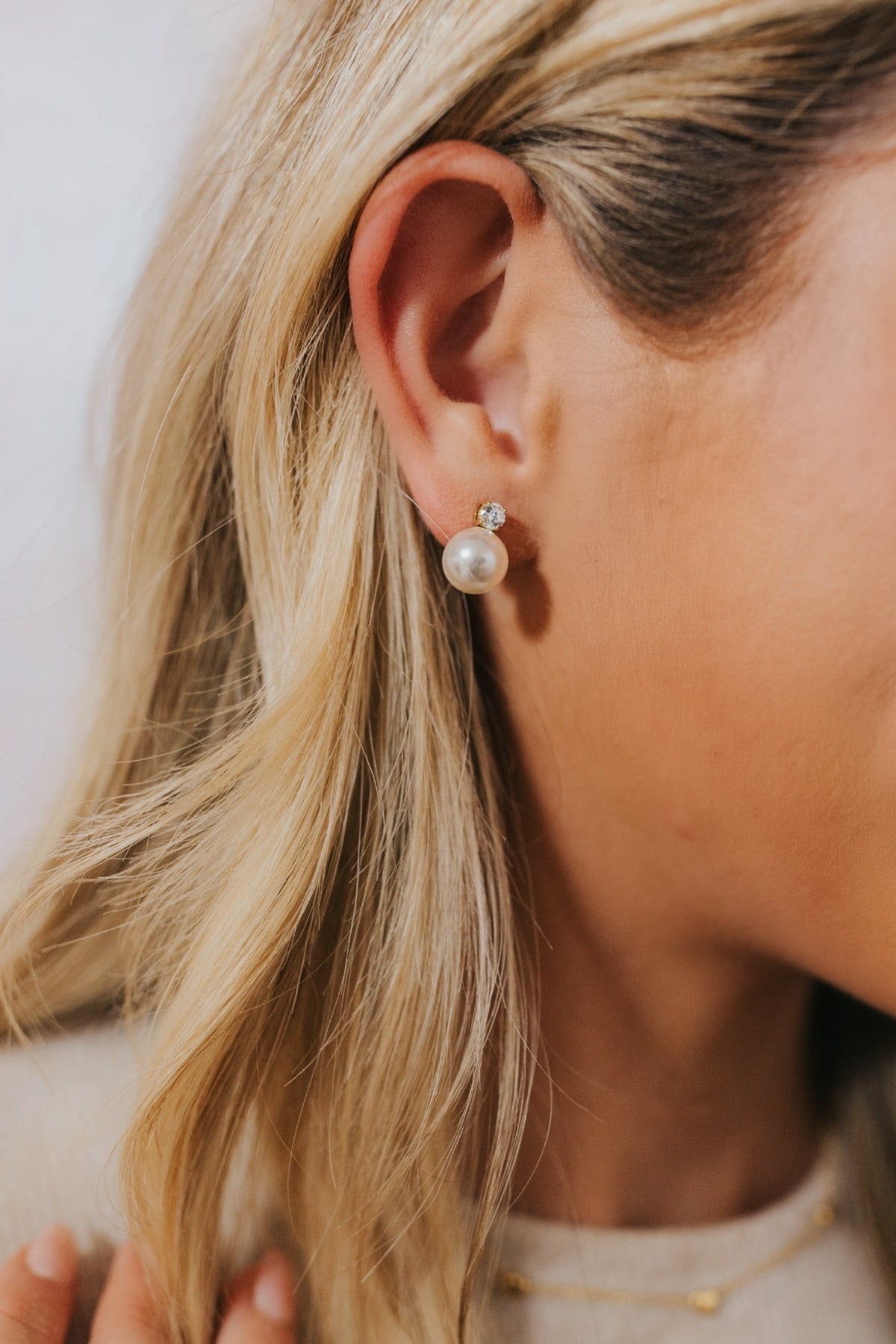 Close-up of Molly pearl stud earrings plated in 18K gold showing the 4mm top stud and 10mm cultured pearl on a white background.