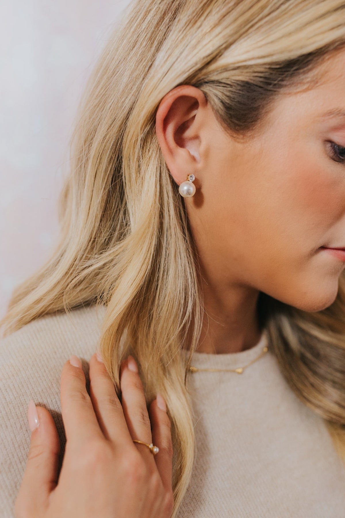 Lifestyle image of Molly pearl studs worn on the ear, highlighting lightweight profile and subtle shine suitable for day-to-night wear.