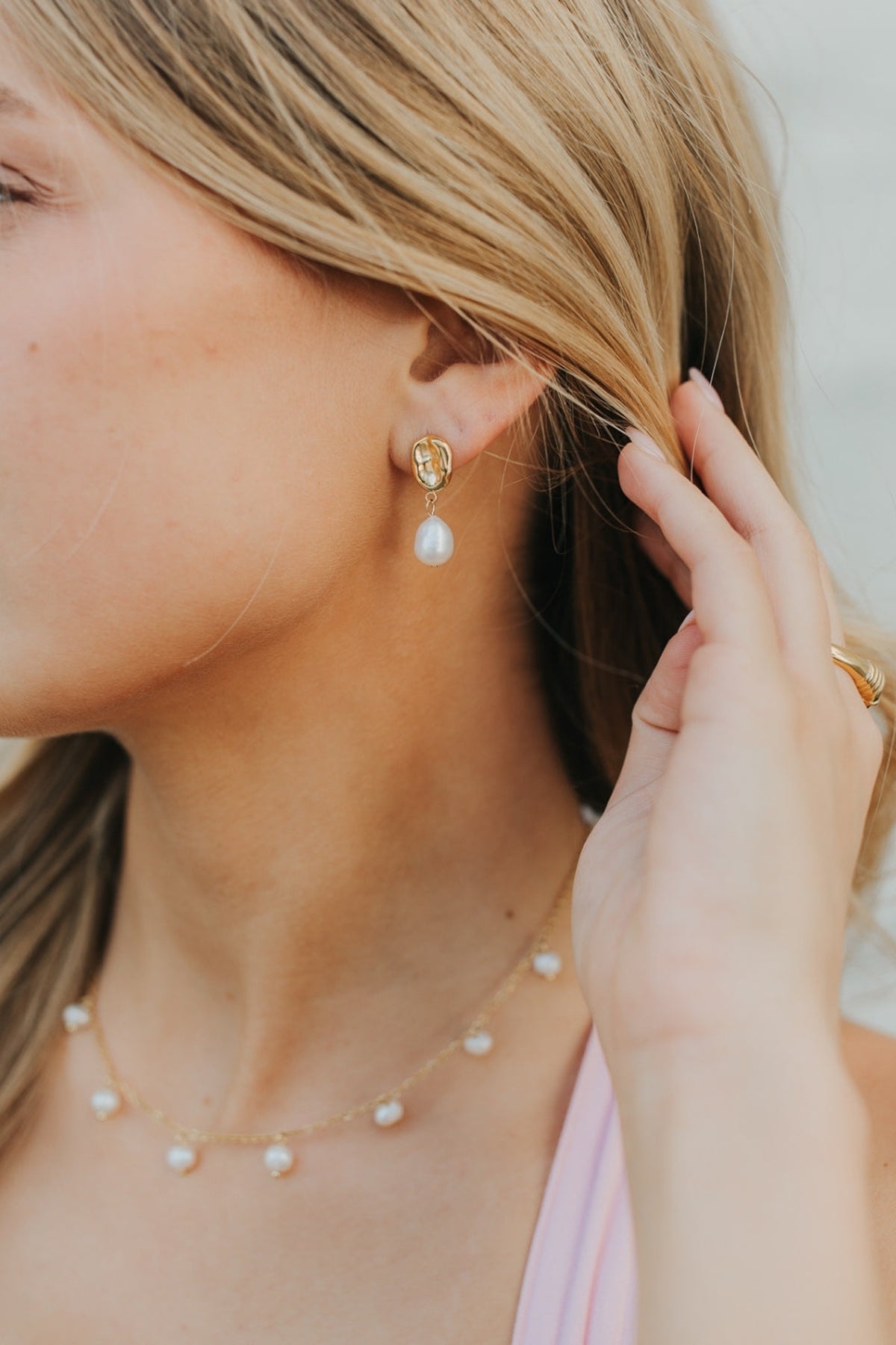 Detailed macro image of Ophelia Pearl Studs focusing on the junction between the gold-plated stud and the freshwater pearl, highlighting craftsmanship.