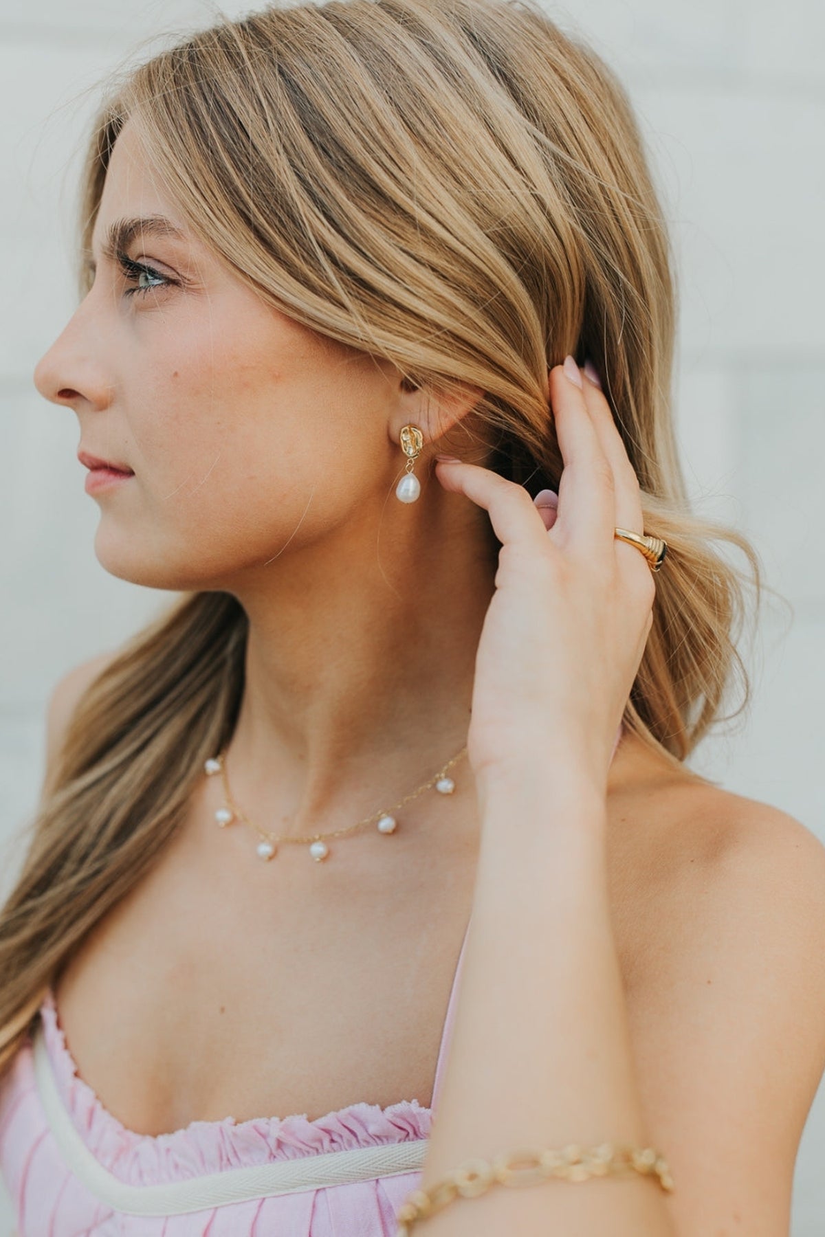 Model-style close-up of Ophelia Pearl Studs worn at the earlobe, illustrating scale, lightweight profile, and classic pearl silhouette.