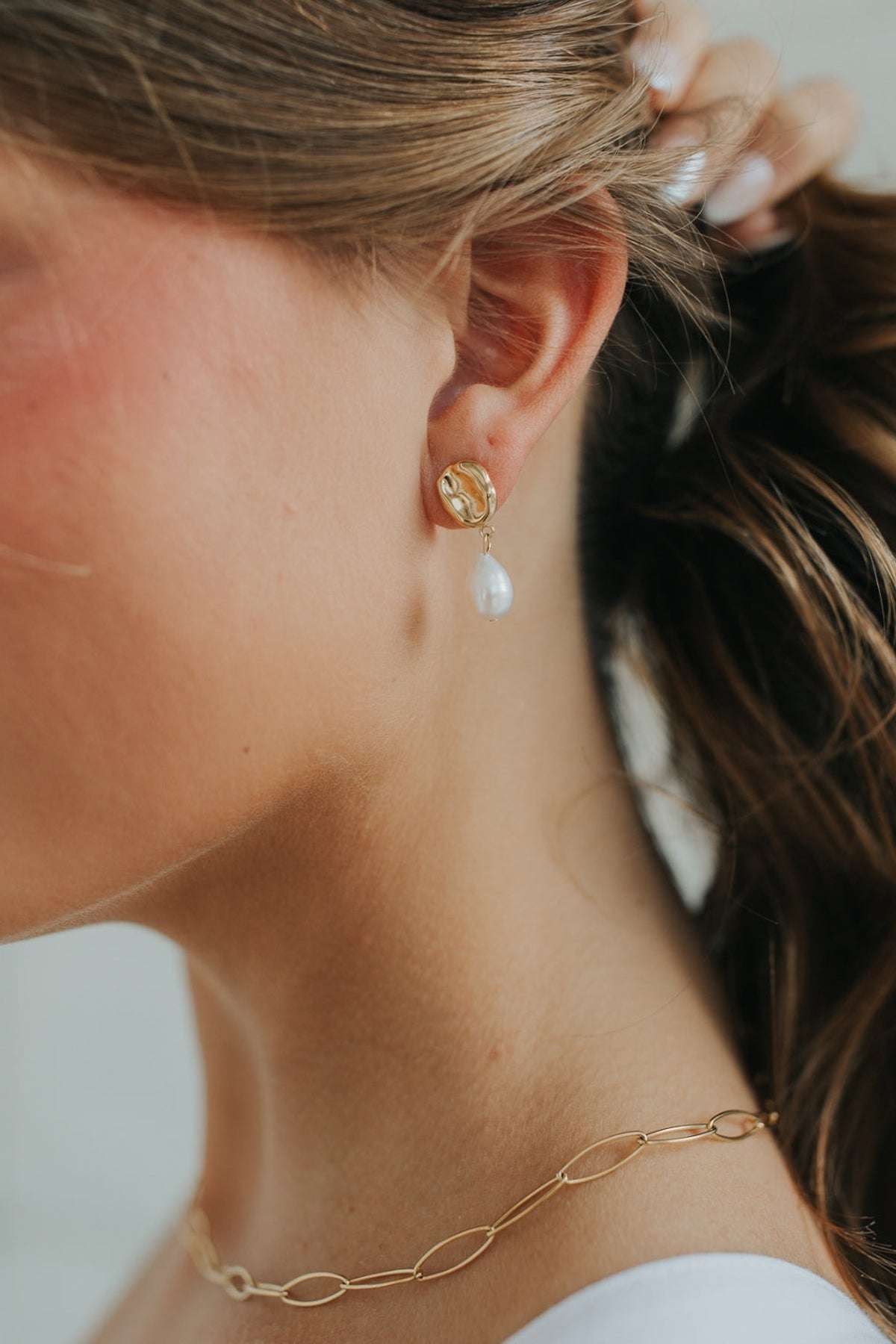 Ophelia Pearl Studs displayed on a flat surface, showing the 25mm total length and natural luster of the freshwater pearls against soft lighting.