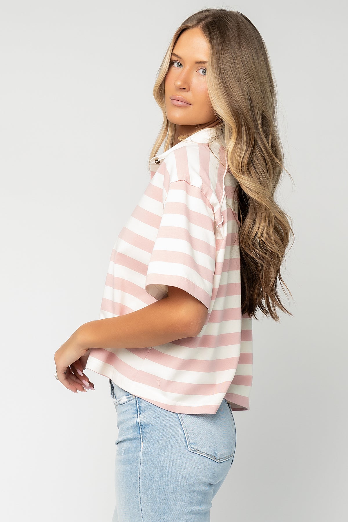 Three-quarter side view of Ruby Striped Top on model showing drape, short sleeve silhouette, and soft midweight fabric.