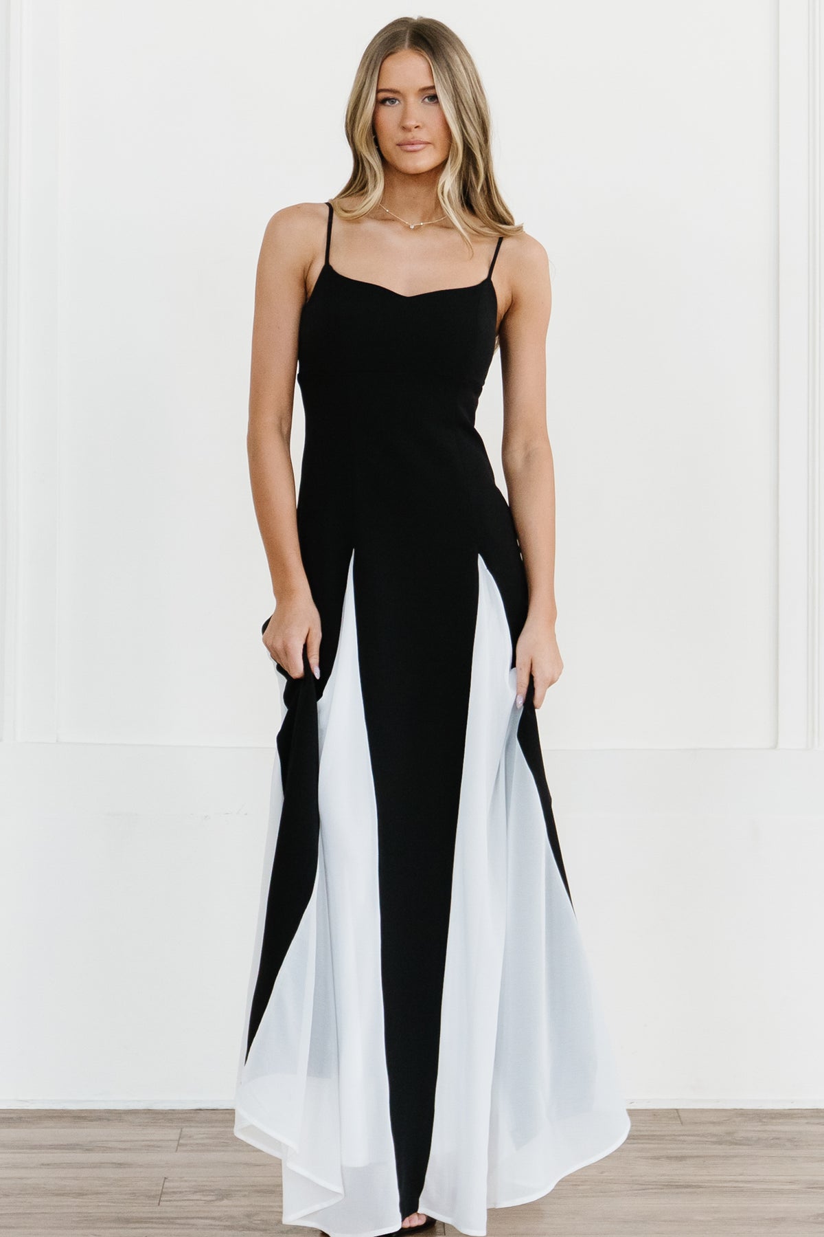 Back view of Adela maxi dress showing zipper closure, adjustable spaghetti straps and contrast white godet panels.