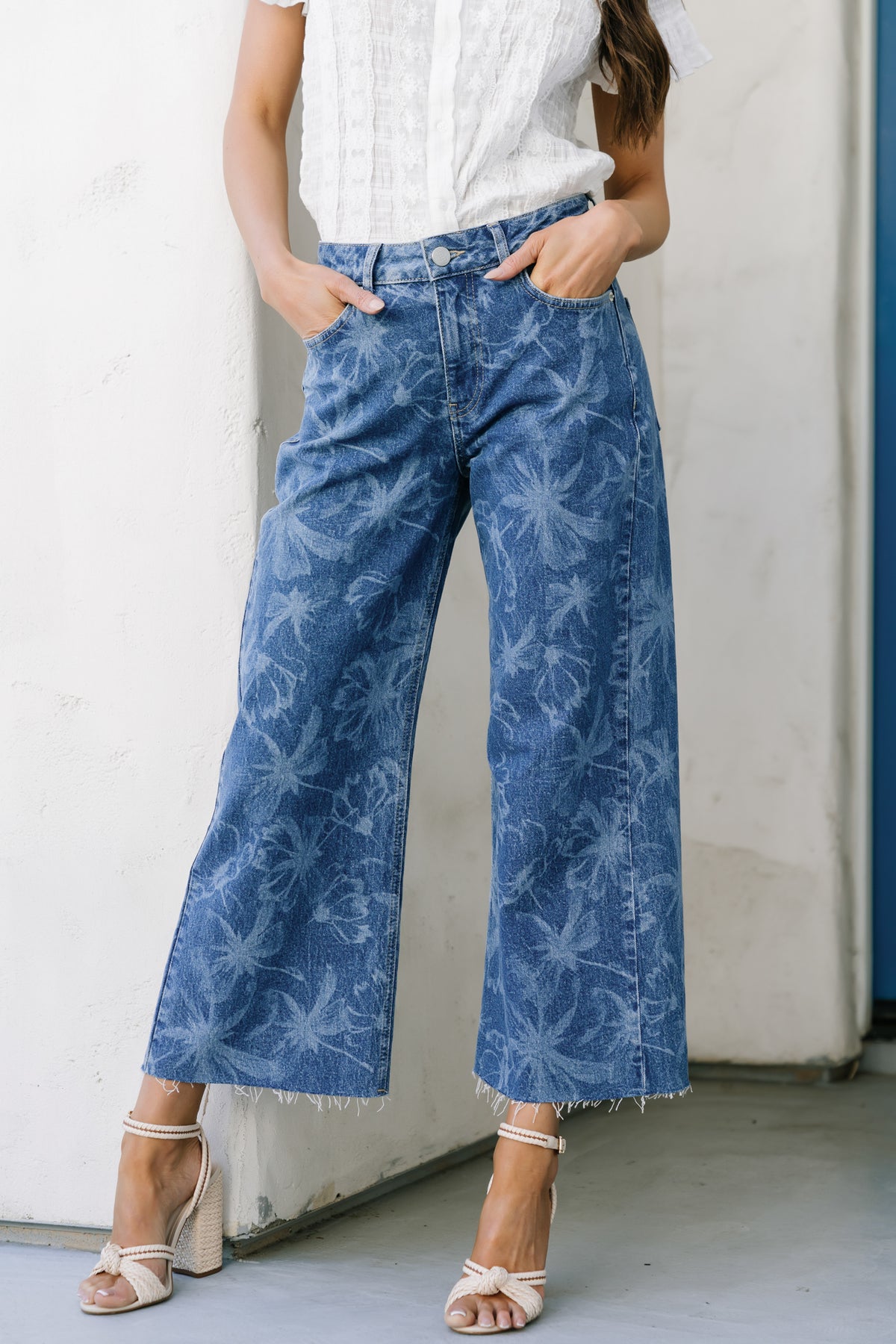 Side profile of relaxed straight leg jeans in medium floral wash on model highlighting cropped length and natural drape (approx. 98 chars)