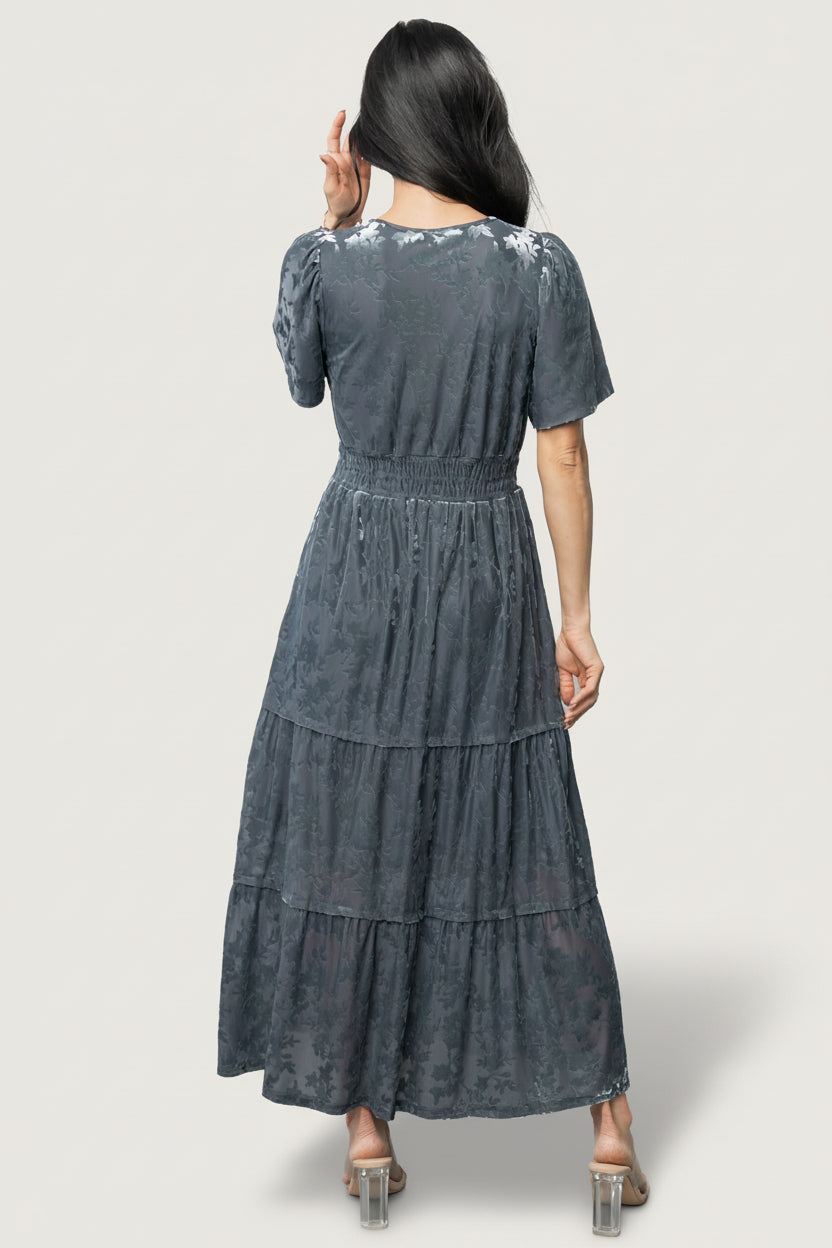 Detail shot of the Bronwyn dress smocked waistband and gathered bodice in Dusty Blue, illustrating shape and stitching.