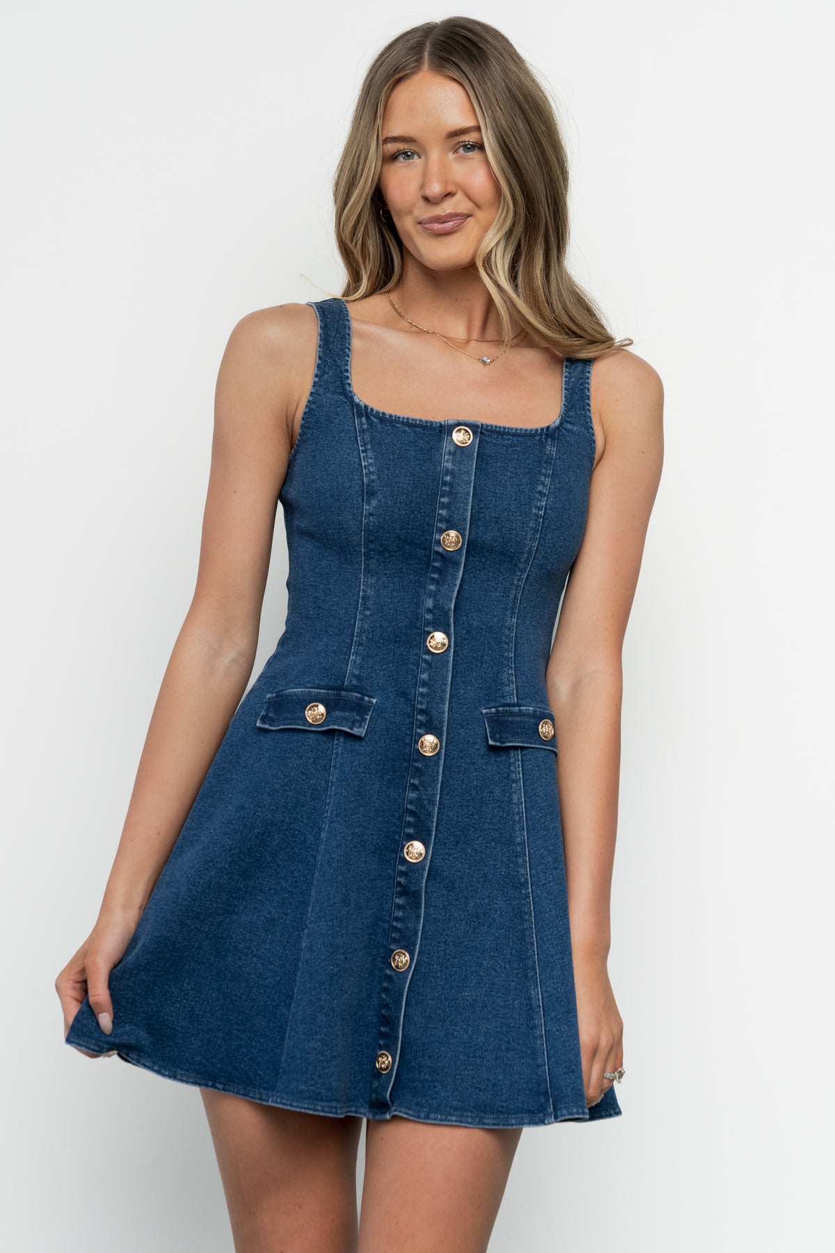 Detail shot of medium-wash denim fabric and tailored seam work on the Mason Structured Denim Mini Dress, showing texture and finish.