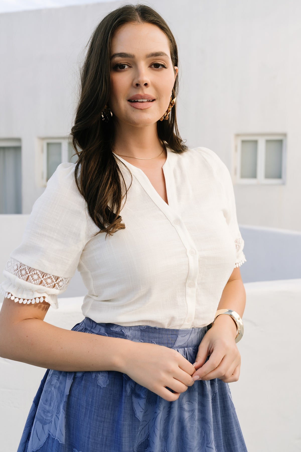Detail image of the Alba Button Up Top's button-front placket and notched V-neck, showing stitching, button details, and the lightweight fabric drape.