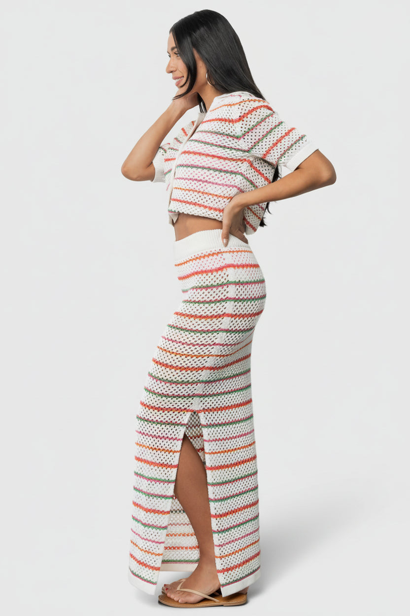 Close-up of Viento cardigan knit texture and multi-color stripes, showing soft crochet stitch, ribbed hem detail and the garment's lightweight drape.