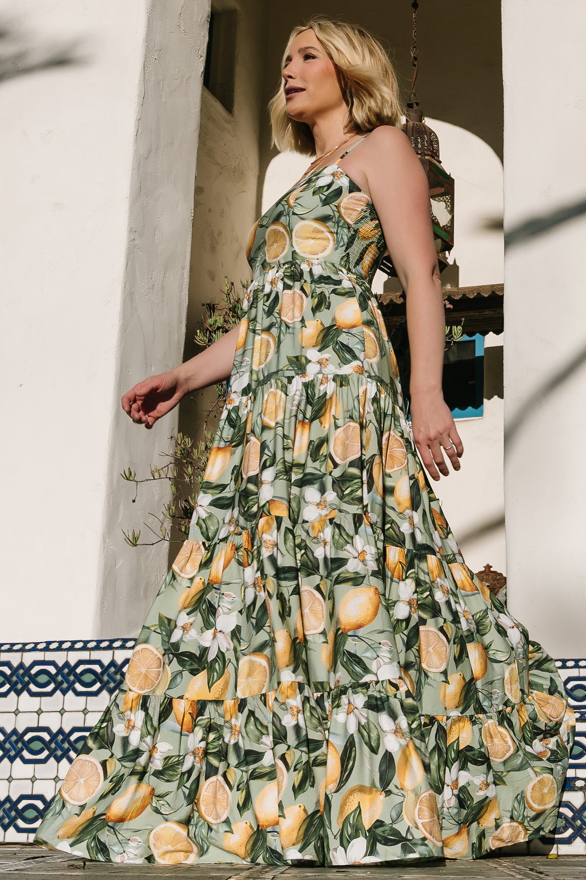 Detail of functional side pockets, gathered waist and tiered construction to show practical design and feminine shaping.
