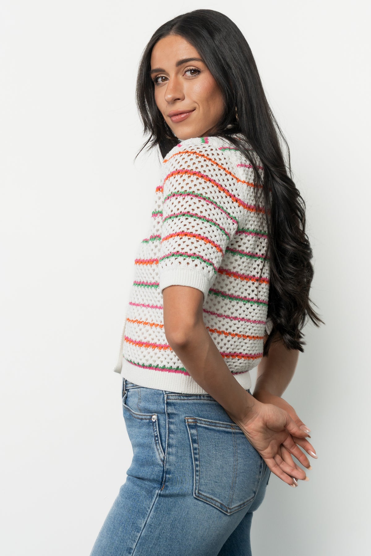 Detail shot of the Viento cardigan front with three buttons, lapel collar and striped pattern, emphasizing button placement and finishing at hemline.