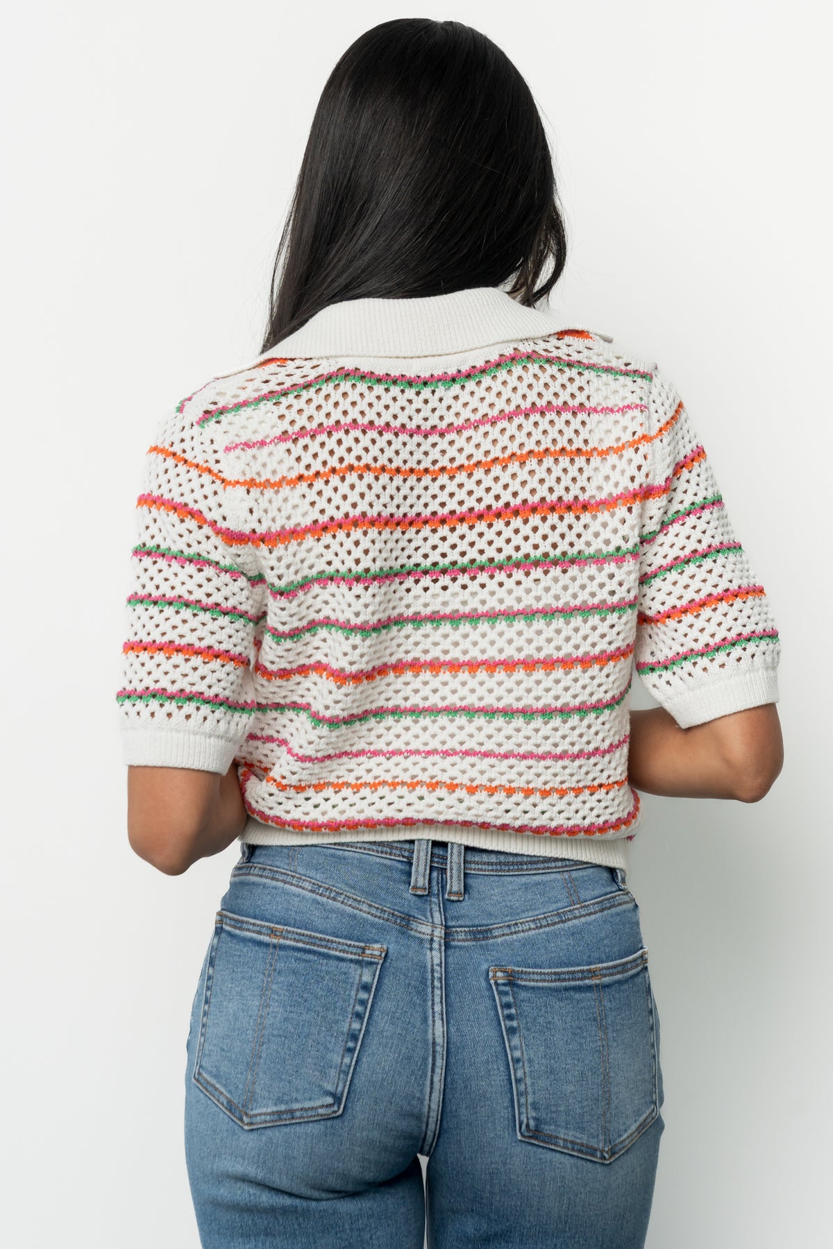 Model styled in Viento Multistripe cardigan paired with medium-wash straight leg jeans, demonstrating versatile, casual outfit combinations.