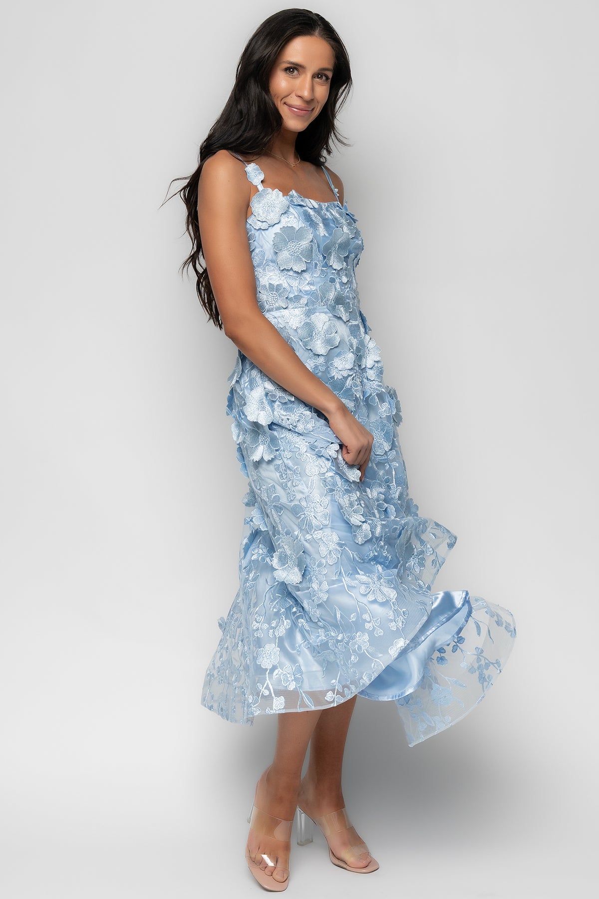 Side view of light blue Soleil midi dress on model showing fitted bodice, structured hem, and graceful midi length.