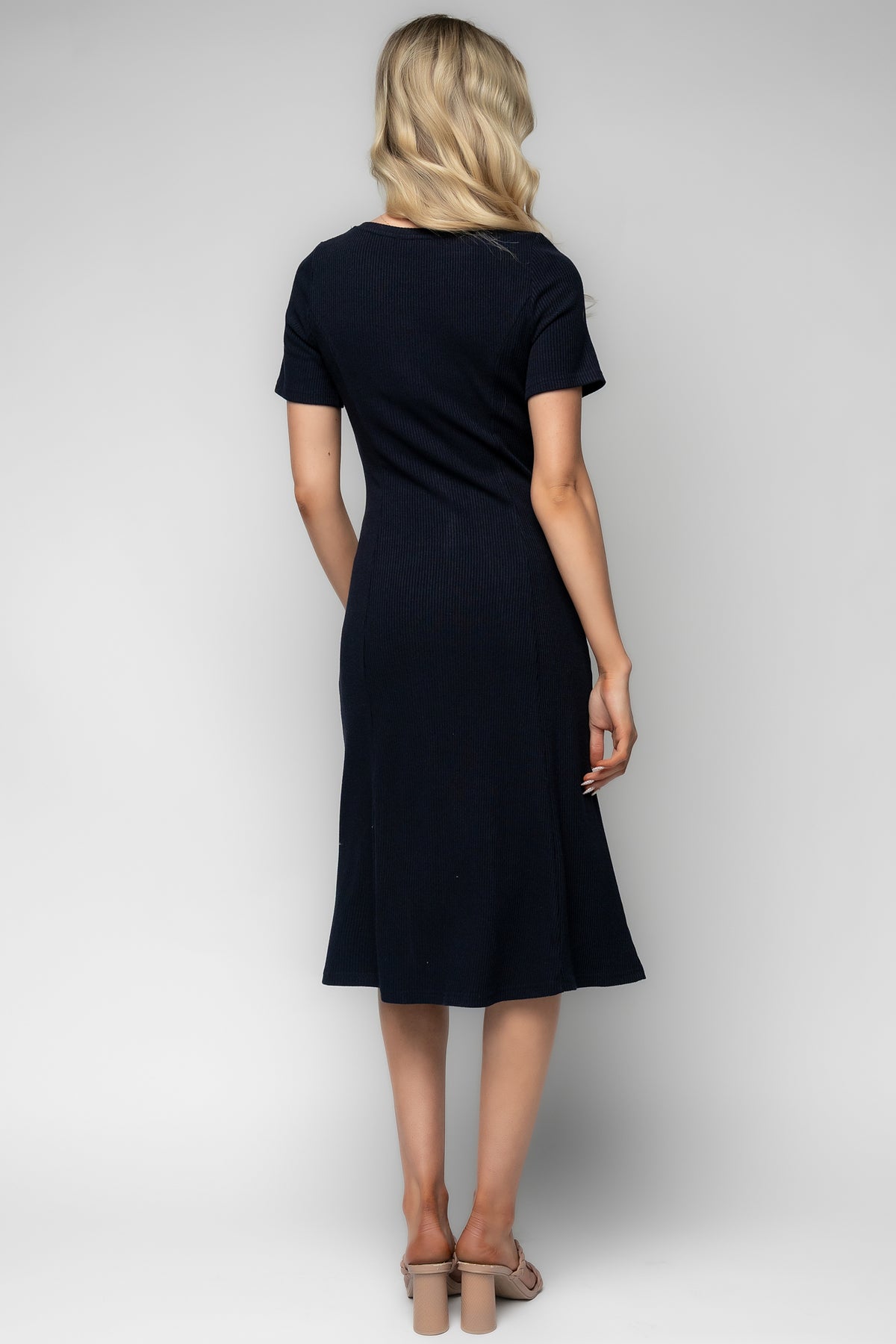 Close-up of the functional front buttons and scoop neckline on the Océane navy ribbed midi dress, showing fabric texture and stitching.