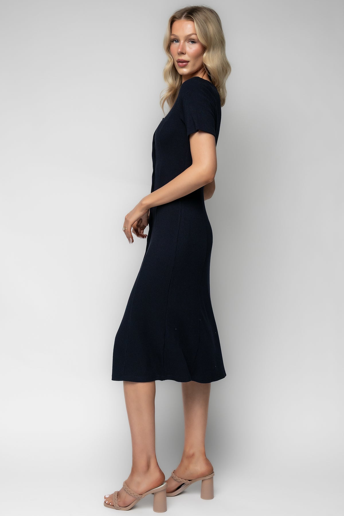 Styled outfit shot of the Océane navy midi dress paired with casual shoes, demonstrating versatile styling for daytime or evening wear.