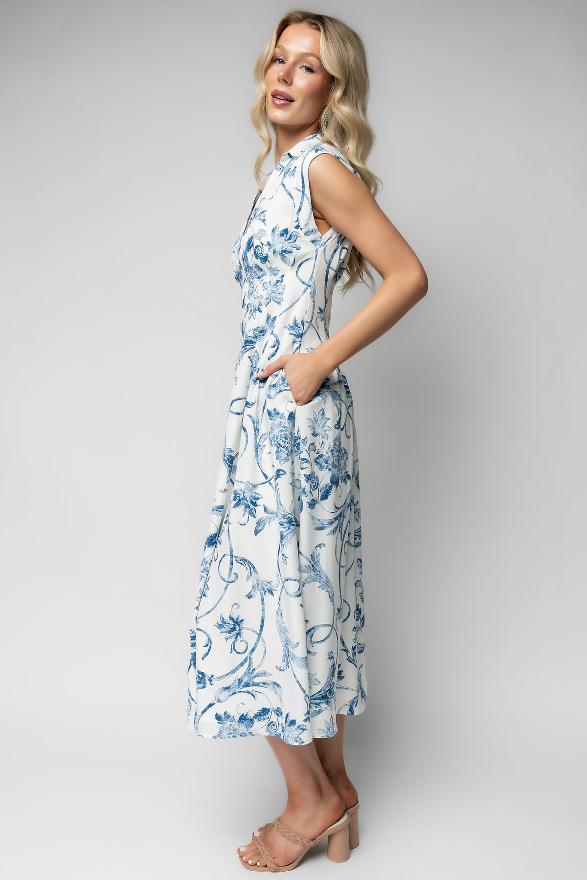 Close-up of functional side pocket and skirt drape on the Tobias midi dress, showing practical design with feminine tailoring.