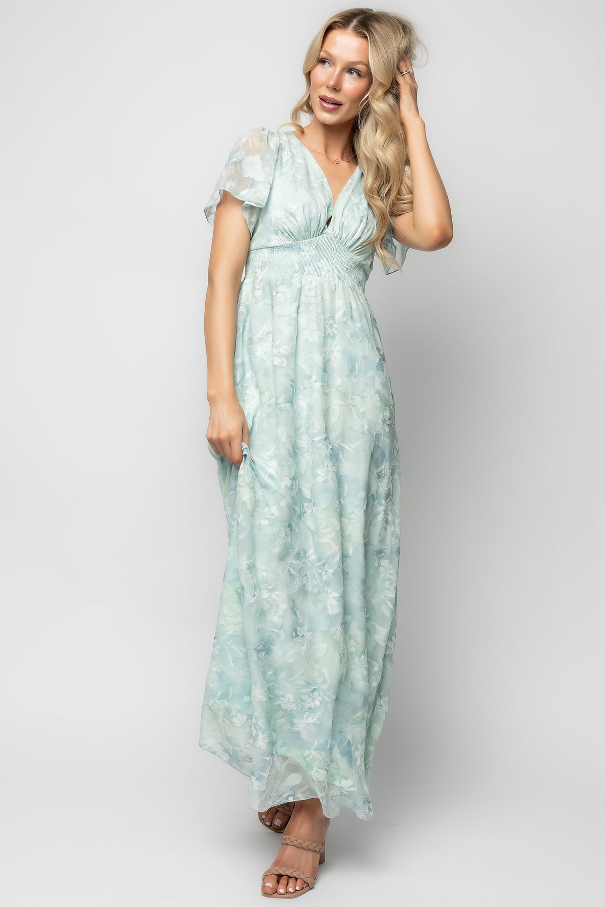 Three-quarter angle of Soline Maxi Dress in light teal floral, highlighting burnout velvet texture, chiffon layers, and gentle drape at the hem.