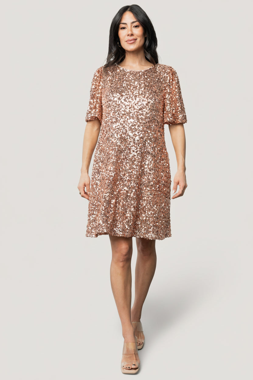 Flat-lay of the Asta Sequin Shift Dress in rose gold showing short length, round neckline, and overall sequin coverage.