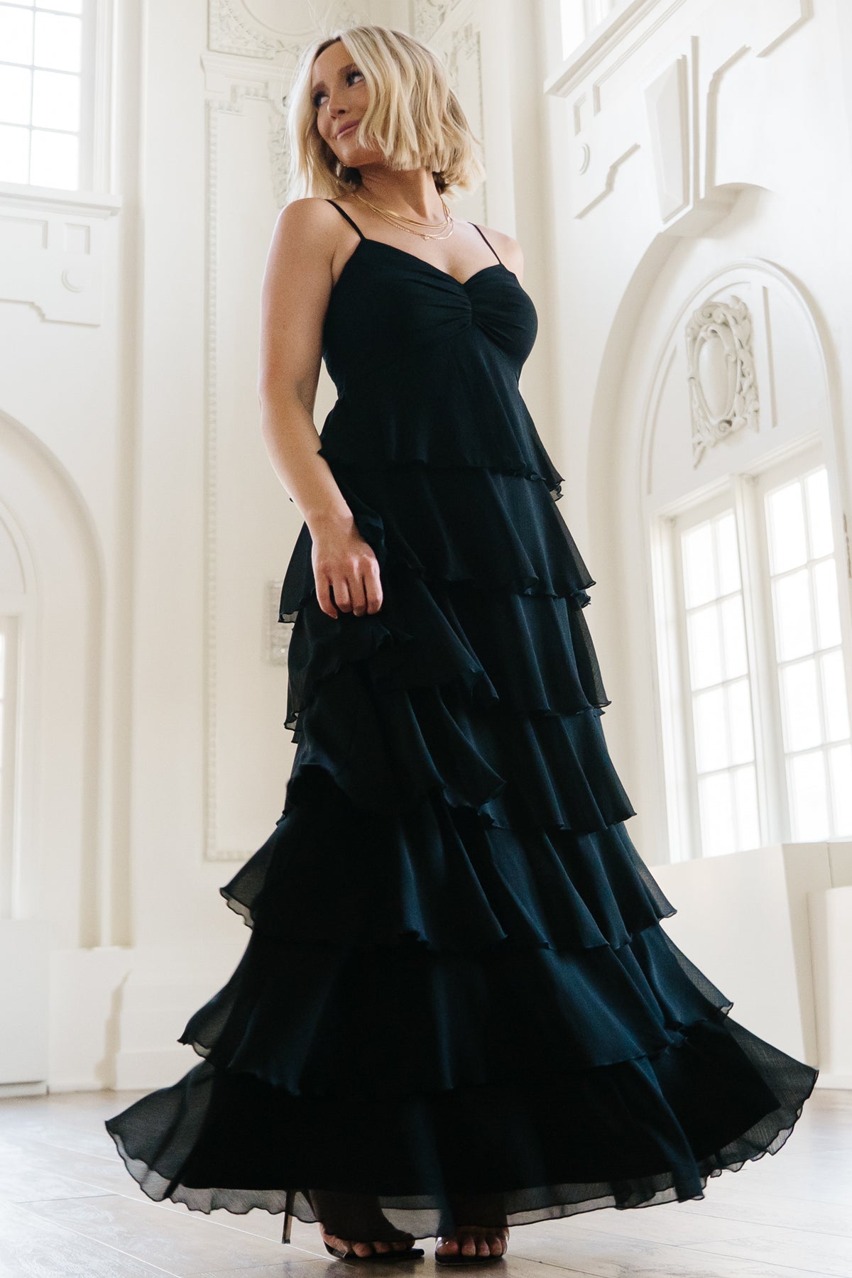 Side view of the Tiana Tiered Maxi Dress in black highlighting the layered ruffle tiers, movement of the chiffon, and smocked back detail.