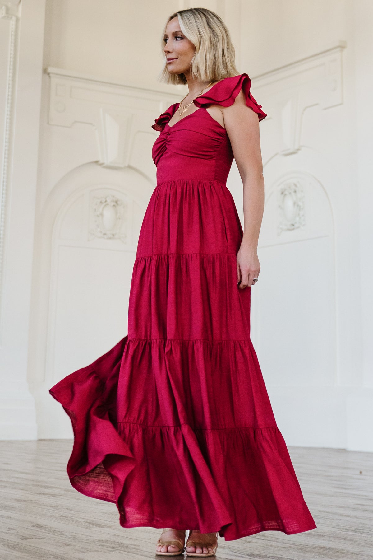 Detail image of the Vivianne Maxi Dress fabric and lining in deep red, showing ruffle tiers and the hemline finish above the lined section.