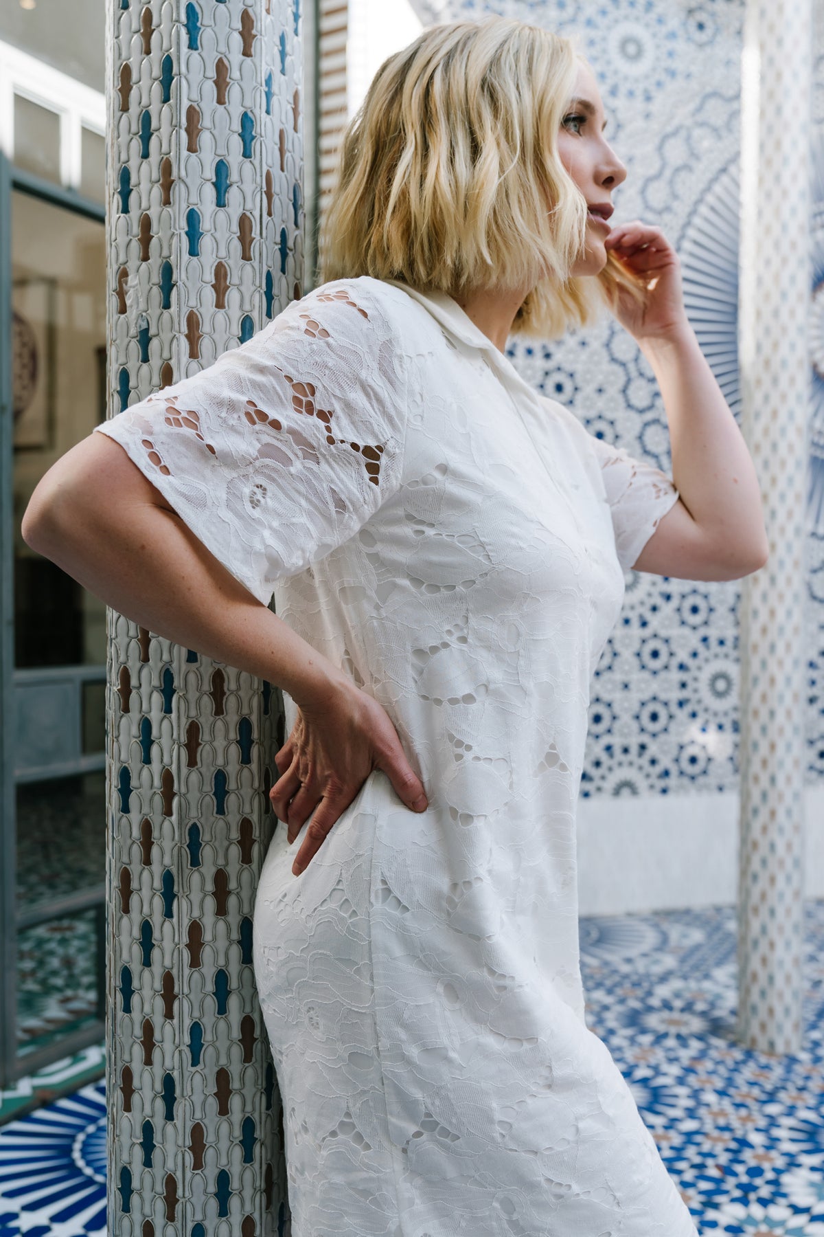 Studio image of Calida Lace Dress front view on model, showing V-neckline, lace overlay and lined bodice without sleeve lining.