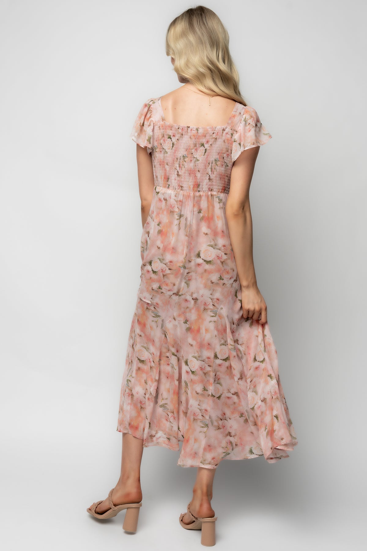 Close-up detail of blush floral print and ruched bust on chiffon Teuila Midi Dress, showing texture, color, and delicate stitching details.