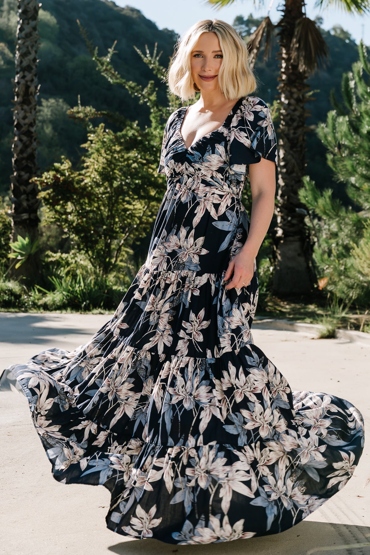 Close-up of Villa Maxi Dress fabric showing muted earth-tone floral print on lightweight polyester chiffon and gathered bust detail.
