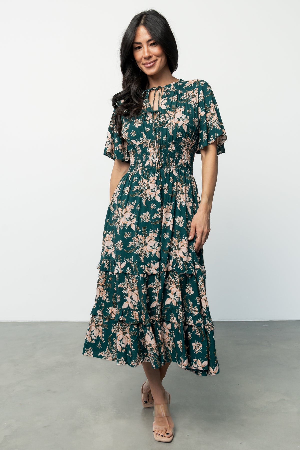 Three-quarter view of the Topaz and blush floral Spell Boho Midi Dress showing sleeve detail, gathered shoulder yoke, and soft skirt movement.