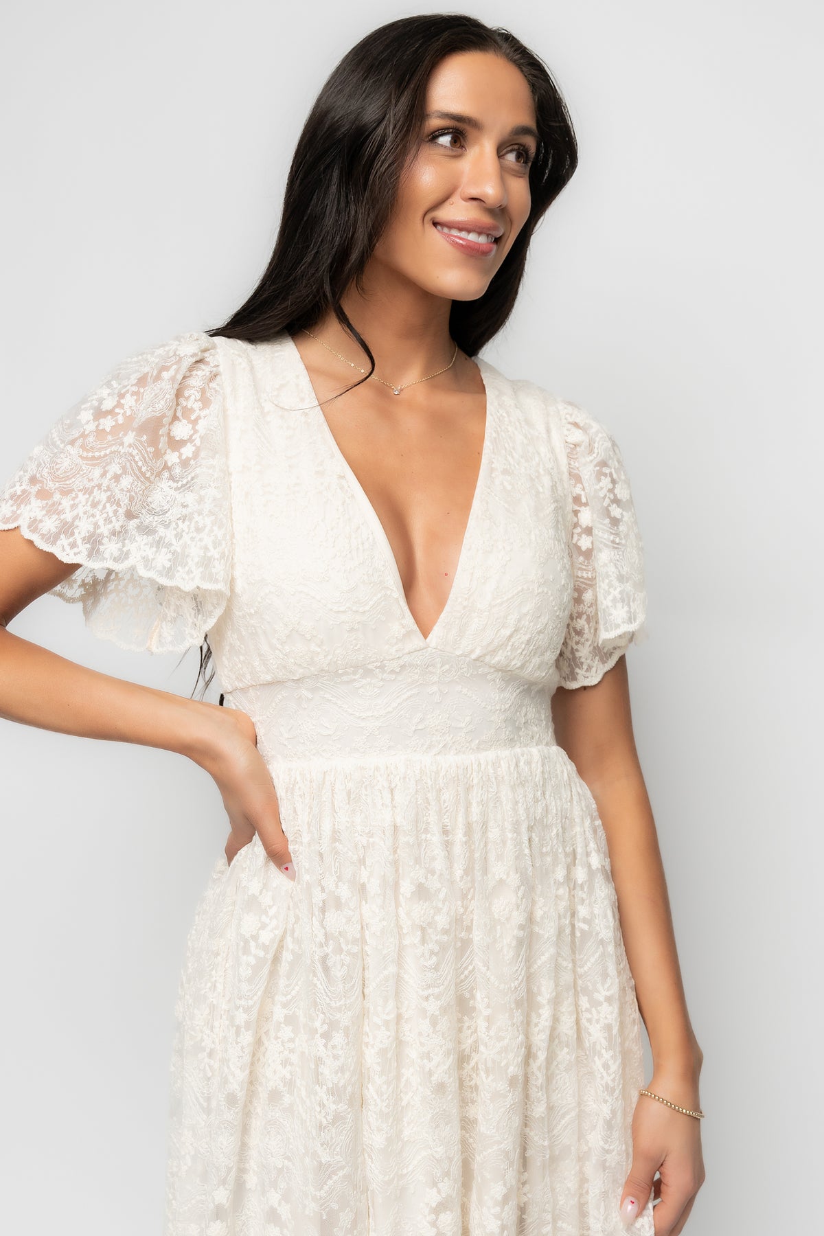 Model styling the vintage-cream lace midi with sandals, demonstrating the dress length, sleeve shape, and romantic, lightweight feel.